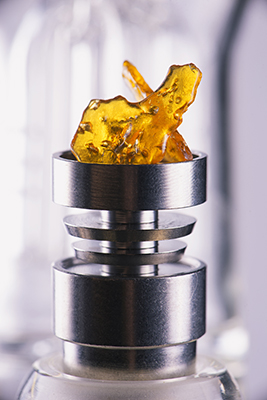cannabis shatter in a dab rig being vaporized