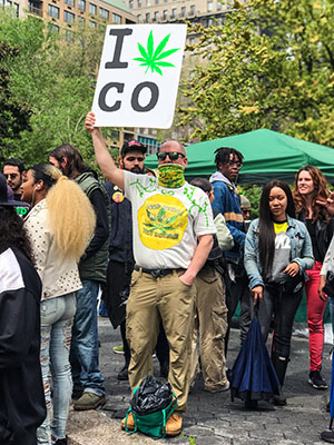 Man Holds Sign At denver Rally Supporting Marijuana Legalizati