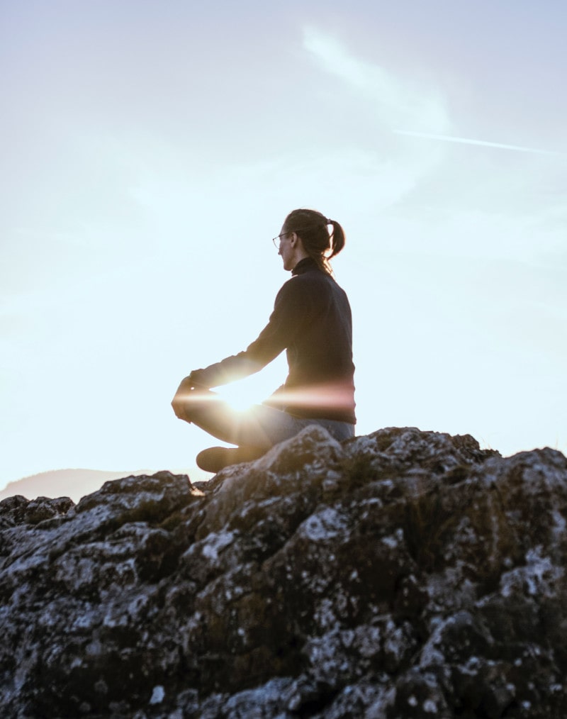 woman meditating in the moutains