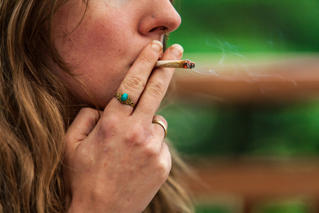 woman smoking hand rolled joint