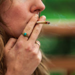 woman smoking hand rolled joint