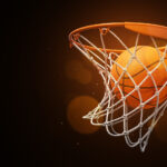 a basketball in the net on a dark background
