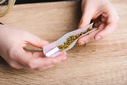 woman rolling a joint closeup