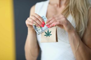 woman accepting cannabis delivery with money on hand