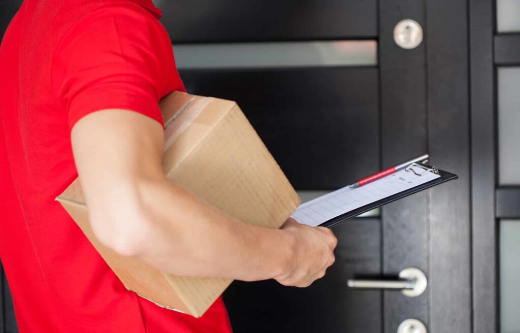 delivery man holding a box of cannabis delivery